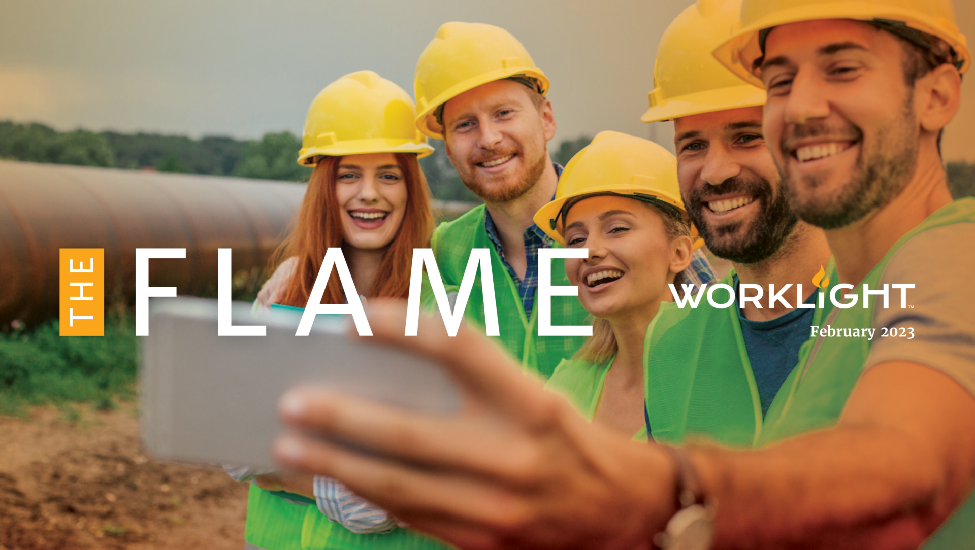 four people in hard hats taking a selfie with the worklight flame logo over the image